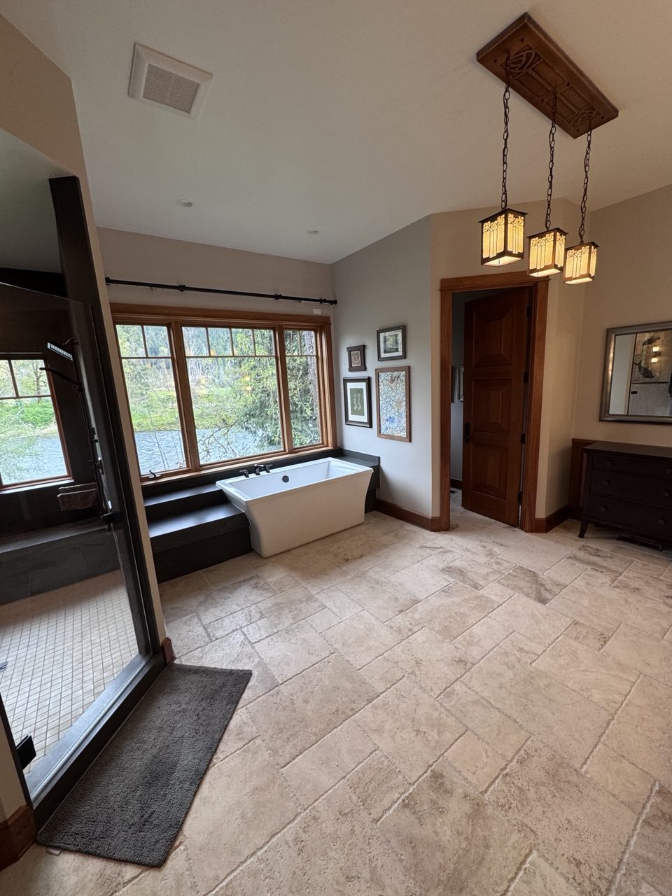 Finished primary bathroom remodel with tile and wood details