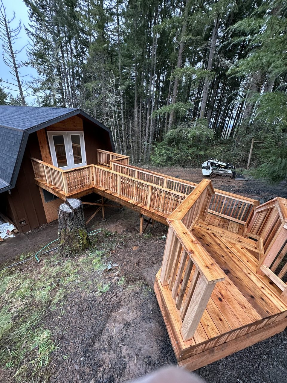 New cedar deck and elevated walkway connecting a home and backyard outbuilding