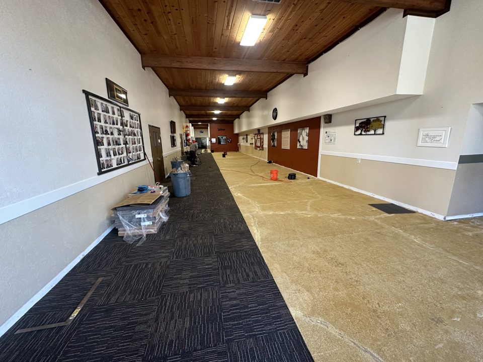 Renovated multipurpose room with finished walls, ceiling, lighting, and flooring