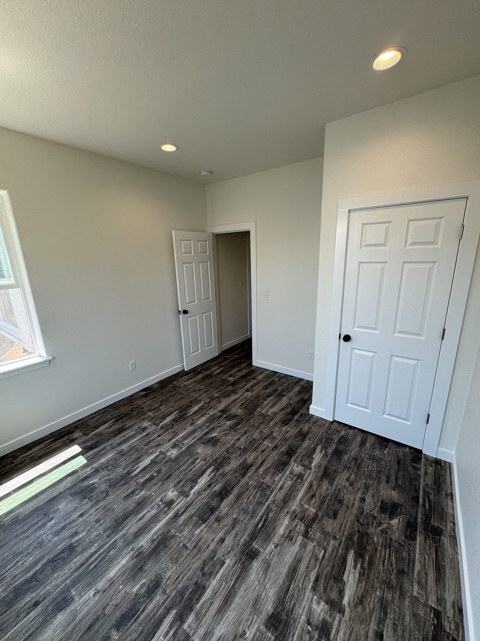 Finished residential room with newly installed wood-look flooring