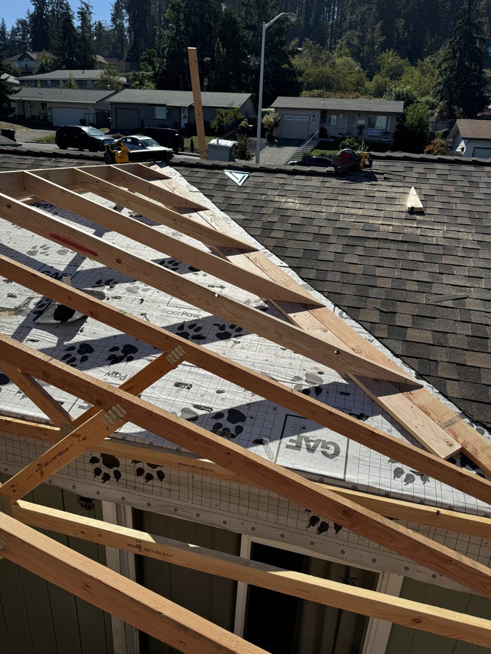 Residential roof trusses installed over weather-protected sheathing